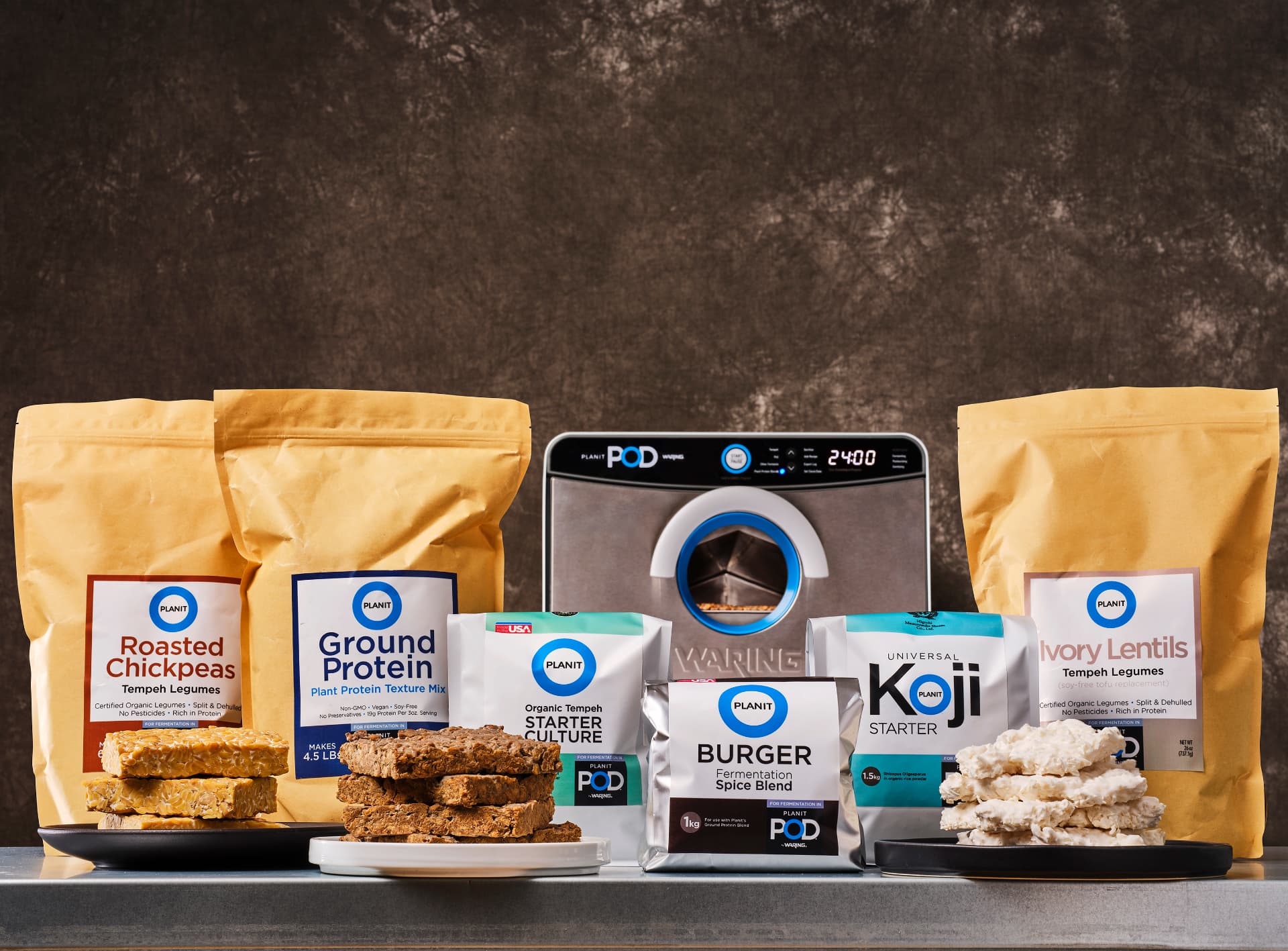 The Planit POD fermentation unit with kraft pouches of tempeh and plant protein and plated fermented foods